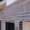 Of course, if the beam is undersized, it will be necessary to provide additional support.  It is likely that it will be necessary to remove the brick veneer in order to replace the garage door header.  