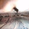 Looking up into a forced-air furnace heat exchanger.  The burners would be behind the camera.  These next two photos show rust on the metal of the heat exchanger.  The interior of a heat exchanger is difficult to view and rarely photographed as the chamber is generally too narrow for a camera.