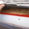 A felt paper (often referred to as "tar" paper) underlayment is required under roof shingles.  As you can see, there is no felt paper here.  In addition, the edge of the OSB roof sheathing is exposed.  This will allow moisture to damage the roof sheathing. 